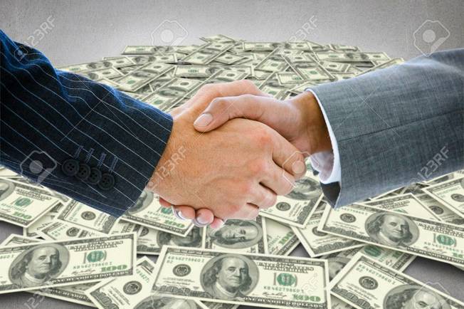 Desktop 38398329 business people shaking hands against pile of dollars